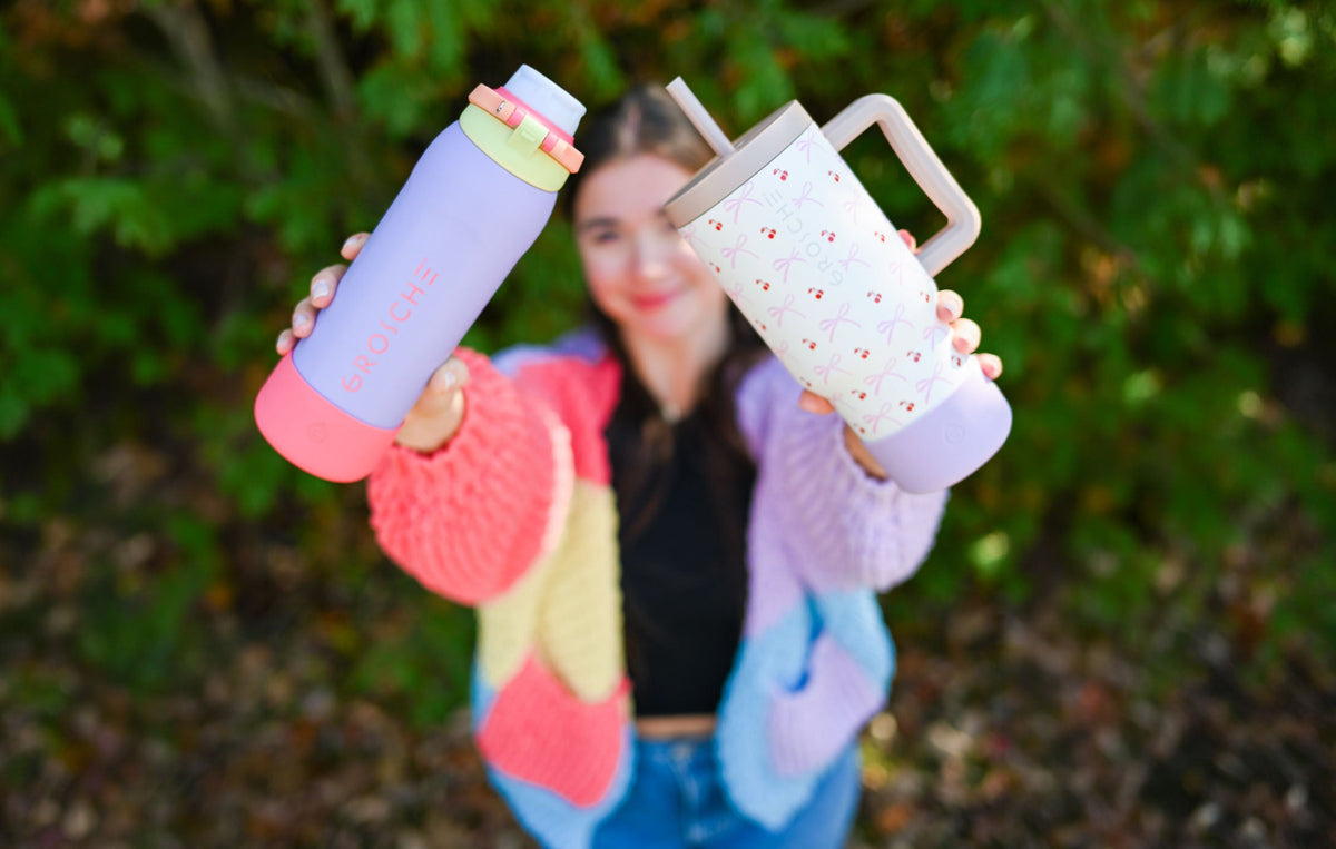 GROSCHE KAMLOOPS reusable water bottles floating in a swimming pool, leakproof flip-top lids, summer hydration lifestyle photo