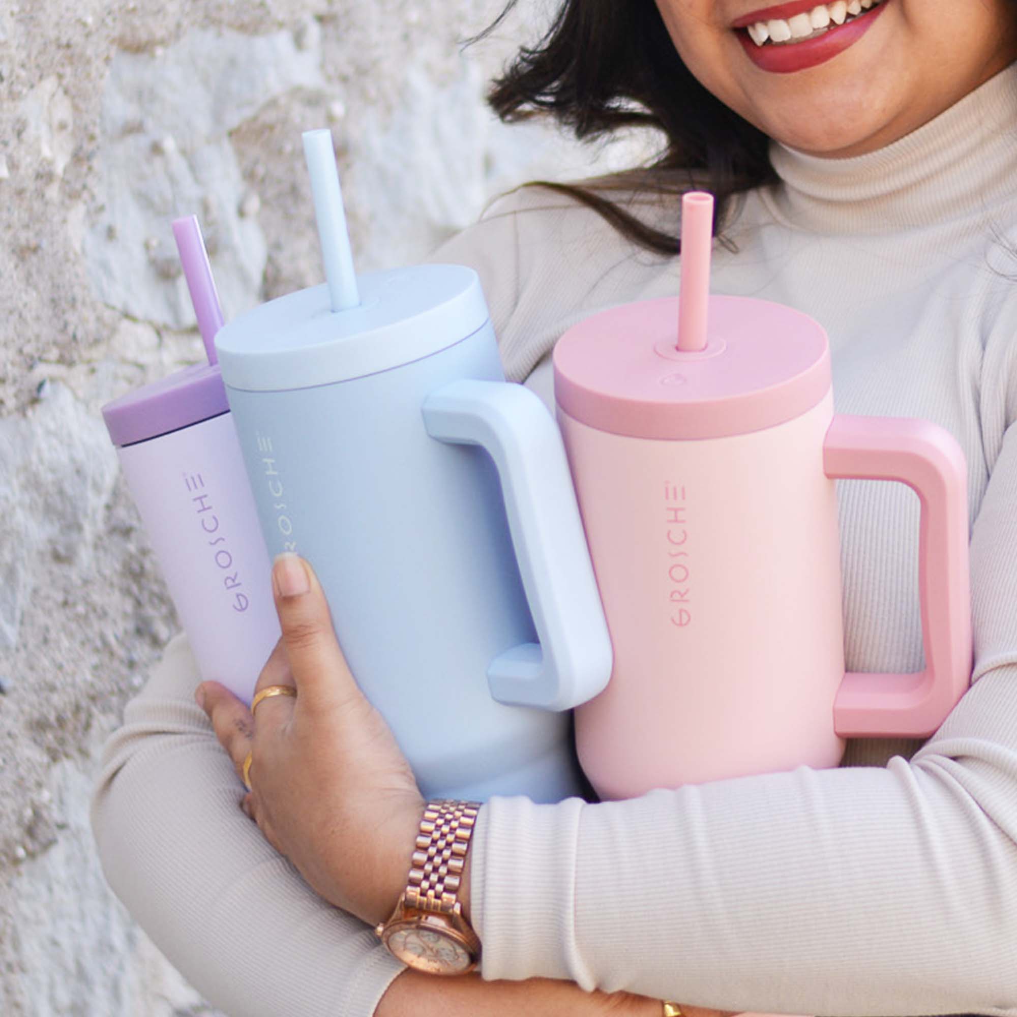 woman with three aspen 40oz insulated tumbler with straw