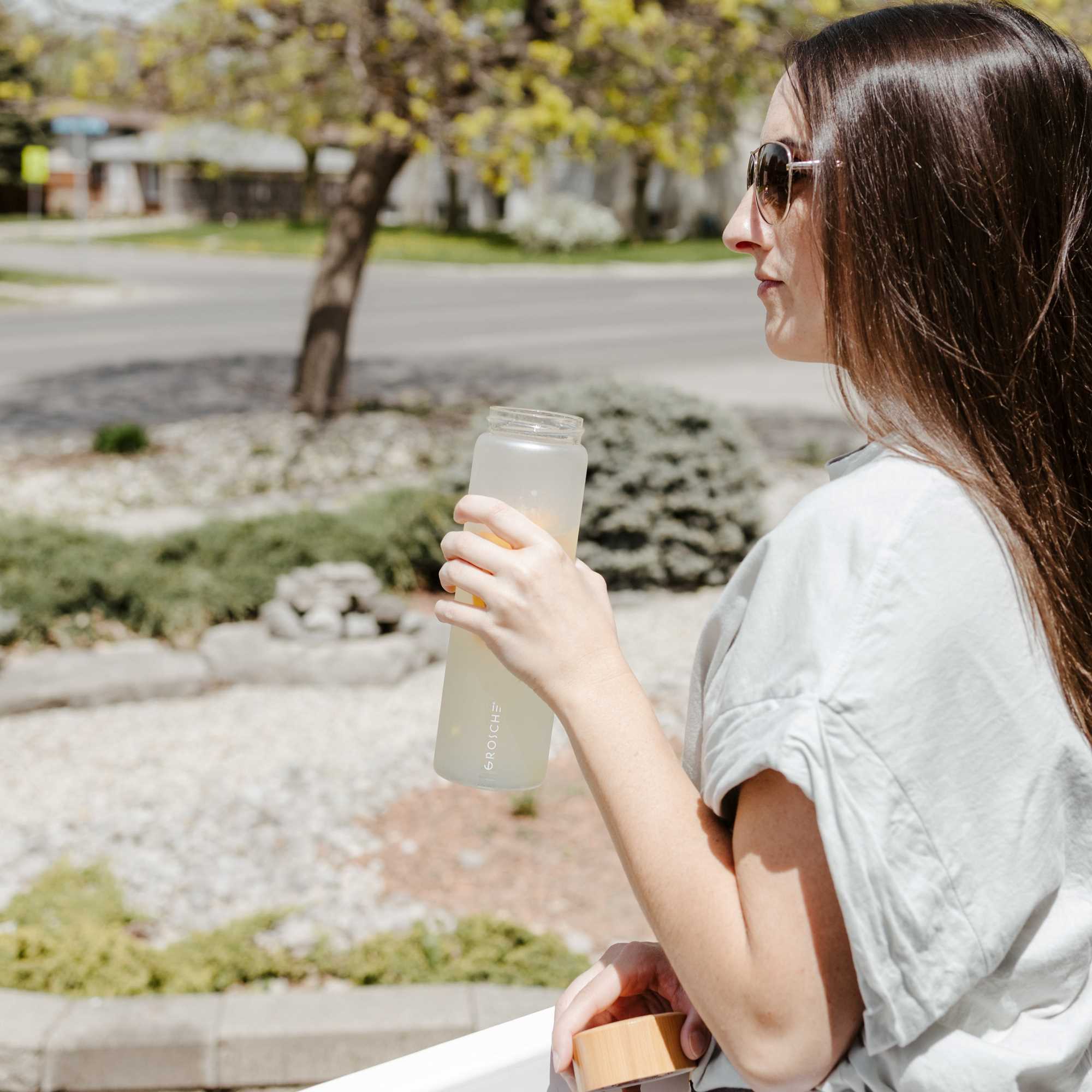 woman with VENICE glass water bottle