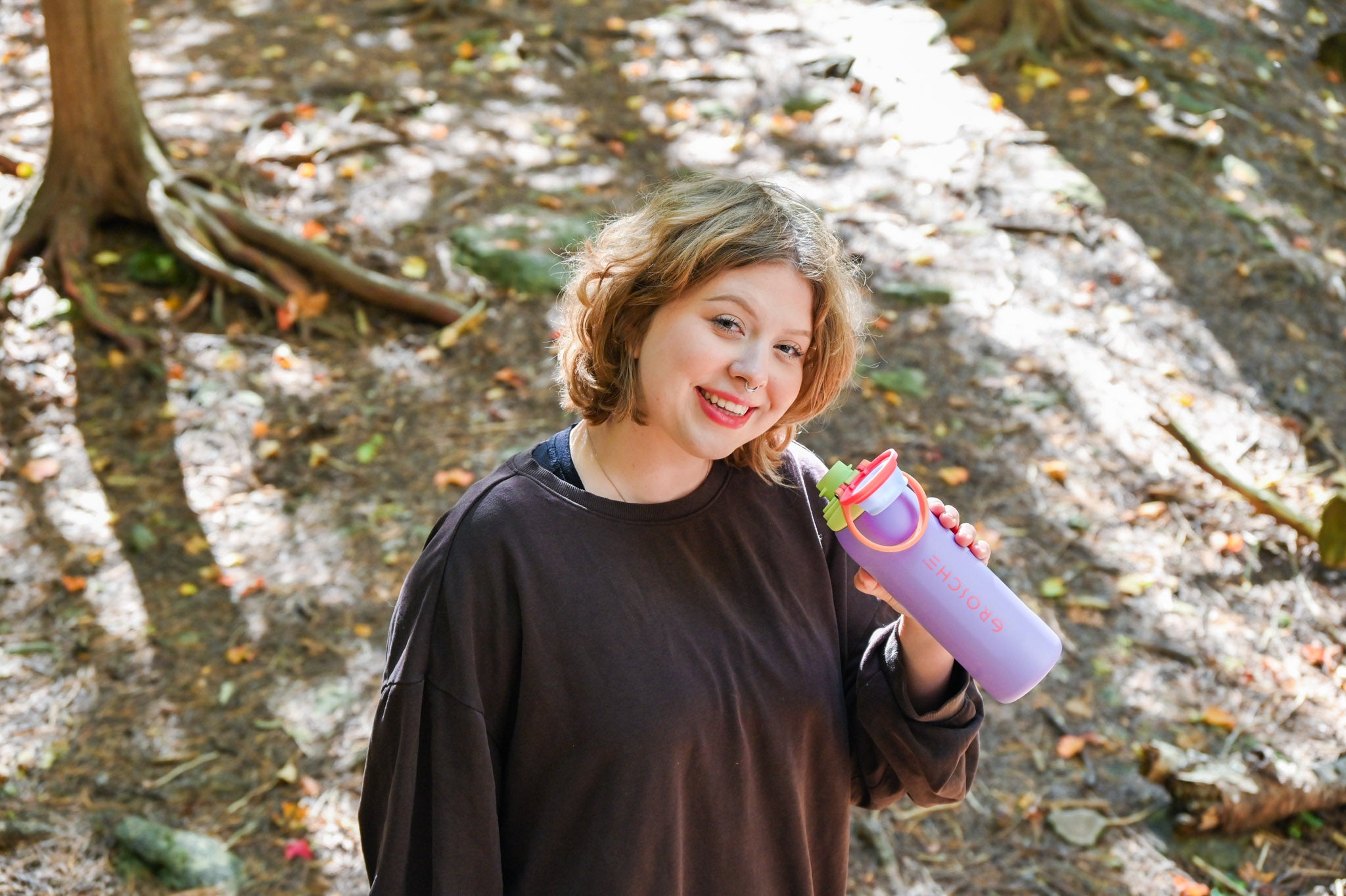 GROSCHE Kamloops Person holding a purple water bottle outdoors.