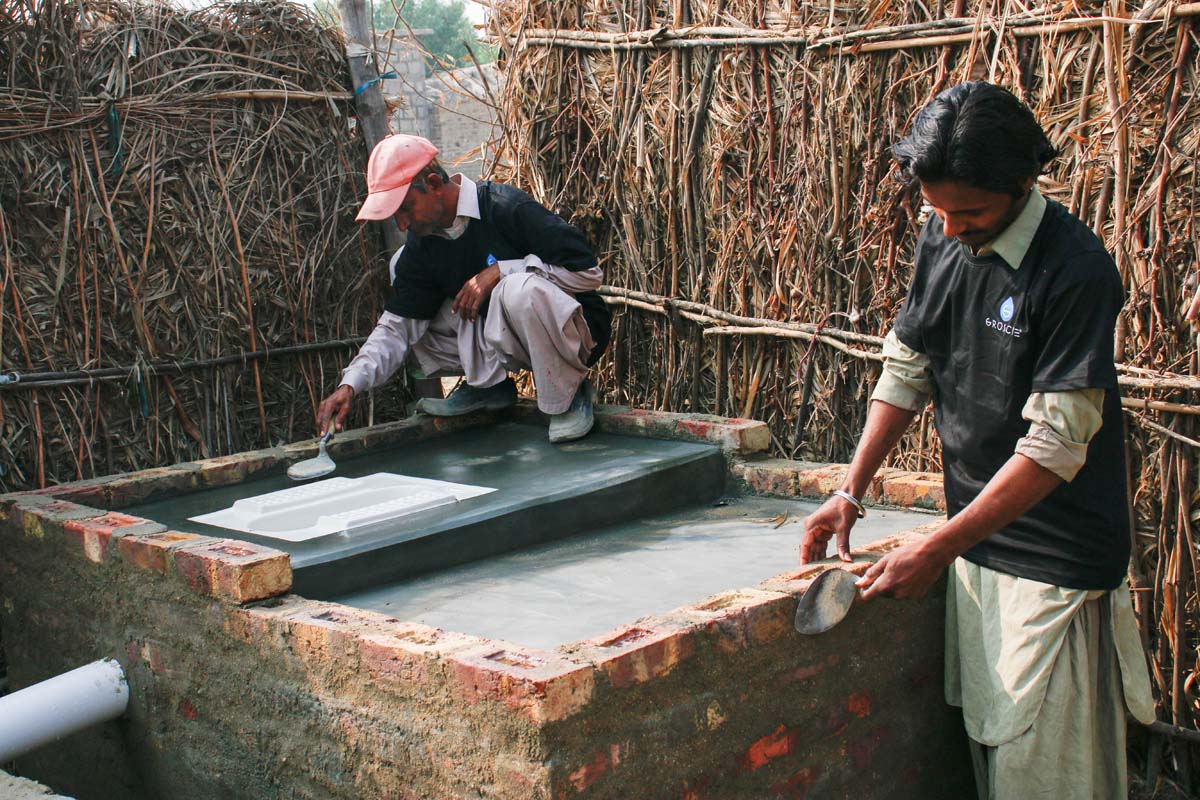 GROSCHE Safe Water project person building a latrine toilet safe water