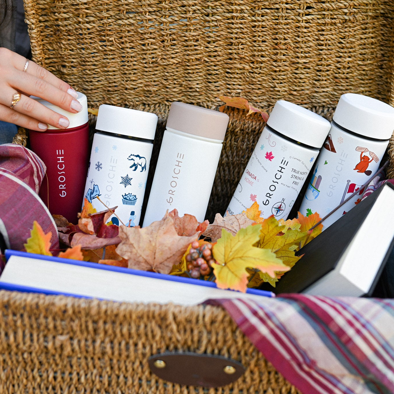 Five Toronto infuser tumblers in a woven picnic basket.