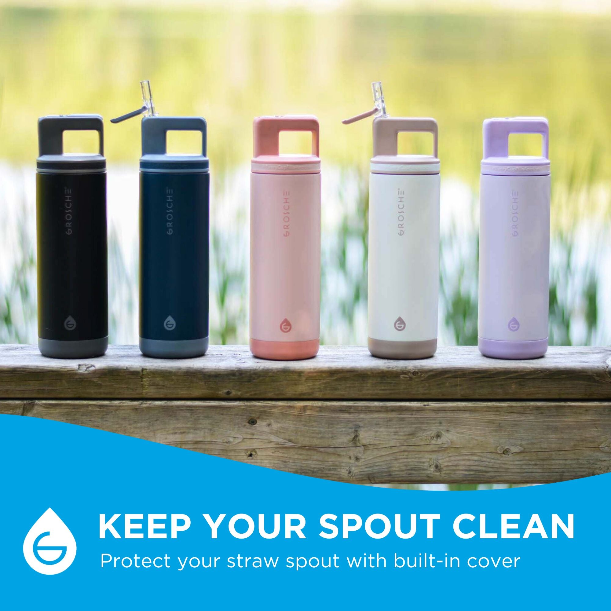 Five colourful water bottles on a wooden railing with a blurred lake in the background. 