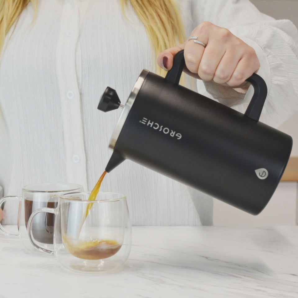 Woman pouring coffee from Grosche black dublin into glass