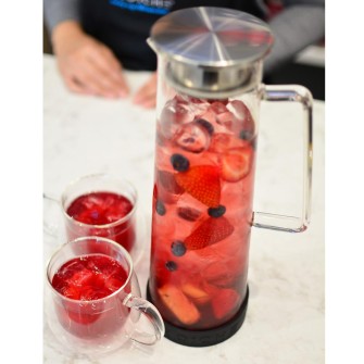 BALI-water-infuser-pitcher-GR-267-and-Fresno-cups-with-handle-GR-335-with-red-infused-tea-drink-on-counter-portrait-view-above