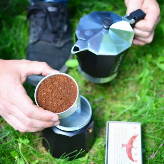 Adding fine ground coffee to the Milano Moka Pot to make camping coffee