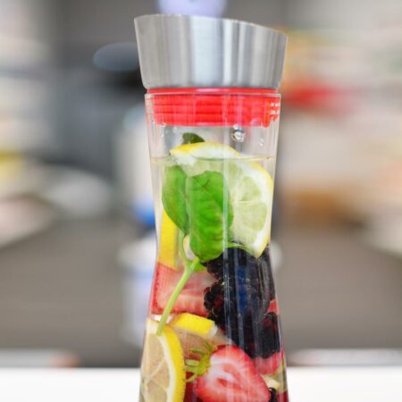 Grosche-rio-sangria glass bottle- water-and-fruit-infuser-top-half-close-up-with-fruits