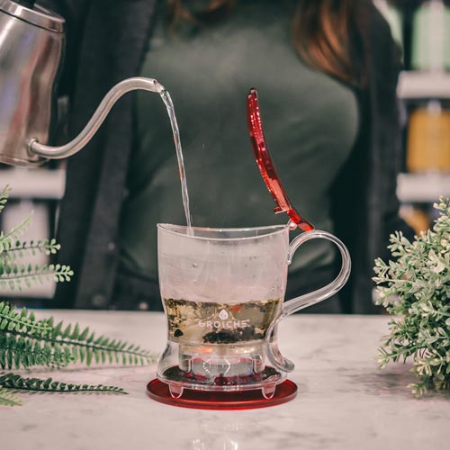 GROSCHE aberdeen red loose leaf tea maker adding hot water to teapot