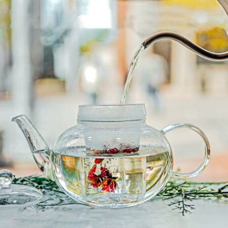 GROSCHE monaco teapot for loose leaf tea with glass infuser pouring water into teapot