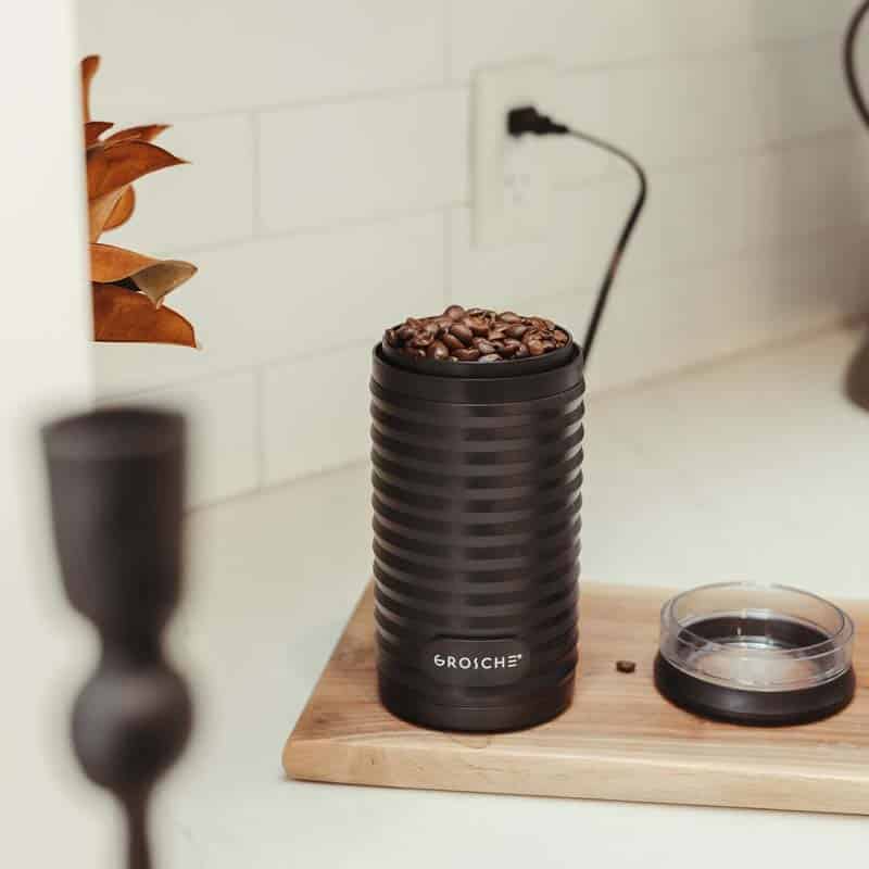 BREMEN Blade Electric Blade Coffee Grinder sitting on counter with coffee beans